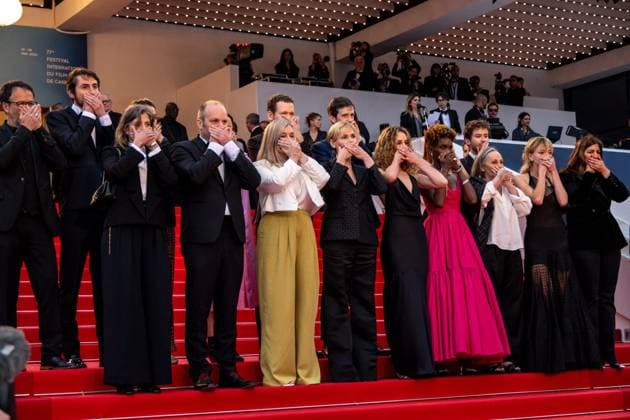 Cannes - Judith Godreche Me Too Action at Screening of Mad Max Furiosa AAR Judith Godreche (center) and her daughter Tess Barthelemy (right) cover their mouth in a ?Me Too? in French cinema action, as they attend the screening of Mad Max ?Furiosa?, as part of 77th edition of Cannes Film Festival, in Cannes, France, on May 15, 2024. Photo by Ammar Abd Rabbo ABACAPRESS.COM Cannes France  Copyright: xAbdxRabboxAmmar ABACAx