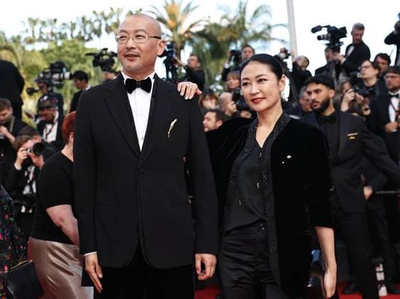 (240517) -- CANNES, May 17, 2024 -- Chinese director Guan Hu (front L) and actress Liang Jing (front R) arrive for the screening of the film Megalopolis at the 77th edition of the Cannes Film Festival in Cannes, southern France, on May 16, 2024. ) FRANCE-CANNES-FILM FESTIVAL- MEGALOPOLIS GaoxJing 