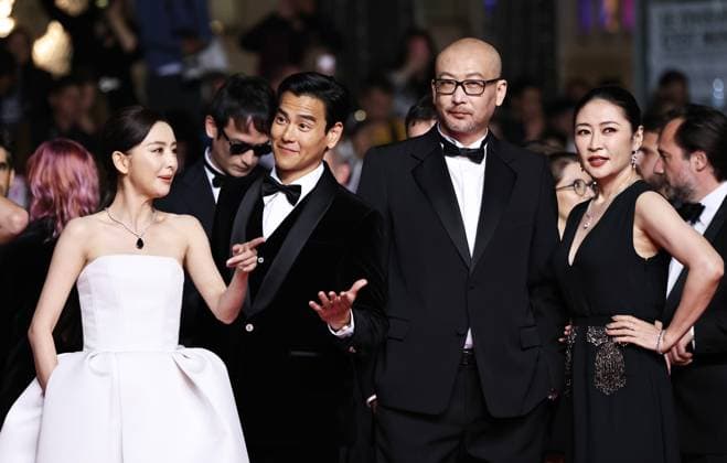(240518) -- CANNES, May 18, 2024 -- Chinese director Guan Hu (2nd R) and cast members Tong Liya (1st L), Eddie Peng (2nd L) and Liang Jing arrive at the red carpet for the film Gou Zhen (Black Dog) during the 77th edition of the Cannes Film Festival in Cannes, southern France, on May 17, 2024. The film Gou Zhen (Black Dog) is in competition for the category Un Certain Regard of the festival. ) FRANCE-CANNES-FILM FESTIVAL-BLACK DOG GaoxJing 