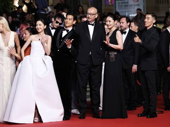 (240518) -- CANNES, May 18, 2024 -- Chinese director Guan Hu (C) and cast members arrive at the red carpet for the film Gou Zhen (Black Dog) during the 77th edition of the Cannes Film Festival in Cannes, southern France, on May 17, 2024. The film Gou Zhen (Black Dog) is in competition for the category Un Certain Regard of the festival. ) FRANCE-CANNES-FILM FESTIVAL-BLACK DOG GaoxJing 