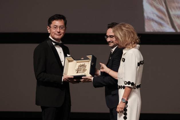 Cannes Palme D Or D Honneur To Studio Ghibli Ceremony DB Goro Miyazaki (L) receives the award from jury member Juan Antonio Bayona (C) and president of the festival Iris Knobloch (R) during the ceremony for the Palme D Or D Honneur to Studio Ghibli at the 77th annual Cannes Film Festival at Palais des Festivals on May 20, 2024 in Cannes, France. Photo by David Boyer ABACAPRESS.COM Cannes France  Copyright: xBoyerxDavid ABACAx