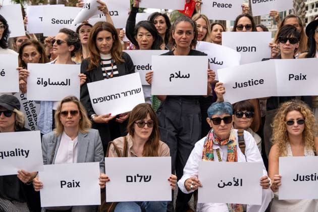 Cannes - Guerrieres De La Paix Flash Mob Action for Gaza and Israel French film director Valerie Donzelli (center) and other women from ?Women warriors of peace? carrying messages in French, Arabic, Hebrew and English stating ?Peace?, ?Cease Fire?, Release the Hostages?, demonstrate on the ?Croisette? in Cannes, to draw attention to the situation in Gaza and Israel, around the 77th Cannes Film Festival, in Cannes, France, on May 20, 2024. Photo by Ammar Abd Rabbo ABACAPRESS.COM Cannes France  Copyright: xABACAx