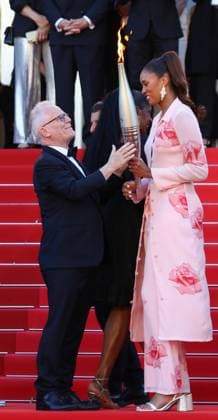 May 21, 2024, Cannes, Cote D azur, France: French basketball player ILIANA RUPERT and Cannes Film Festival General Delegate THIERRY FREMAUX carry the Olympic torch up the red carpet ahead of Marcello Mio Premiere screening at the 77th Annual Cannes Film Festival at Palais des Festivals in Cannes, France Cannes France - ZUMAc179 20240521_zep_c179_099 Copyright: xMickaelxChavetx