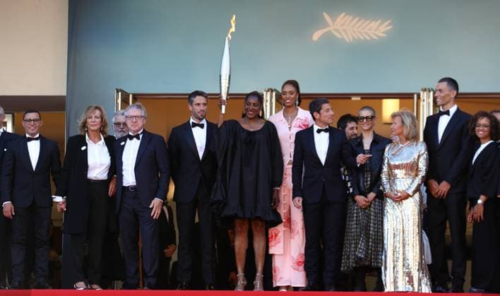 May 21, 2024, Cannes, Cote D azur, France: French athletes of which MARIE-JOSE PEREC, PARIS 2024 President TONY ESTANGUET, THIERRY FREMAUX and IRIS KNOBLOCH carry the Olympic torch up the red carpet ahead of Marcello Mio Premiere screening at the 77th Annual Cannes Film Festival at Palais des Festivals in Cannes, France Cannes France - ZUMAc179 20240521_zep_c179_098 Copyright: xMickaelxChavetx