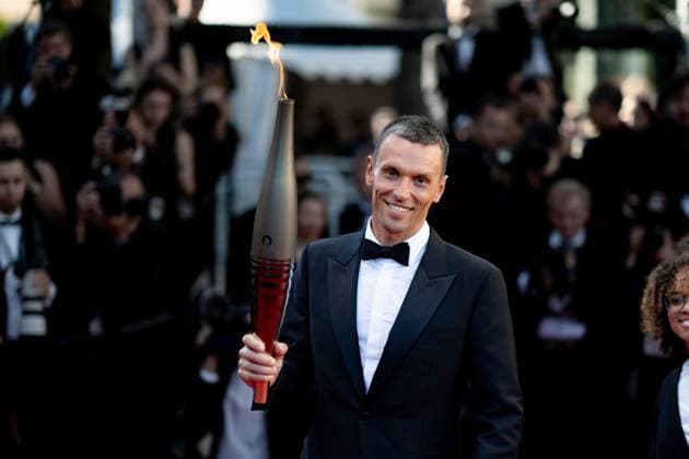 Cannes, France 21th May, 2024 Alexis Hanquinquant carries the Olympic Torch during Marcello Mio Screening red carpet at the 77th annual Cannes Film Festival at Palais des Festivals on May 21, 2024 in Cannes, France CINEMA 77eme Festival de Cannes Red Carpet du film Marcello Mio 21 05 2024 NorbertScanella Panoramic 