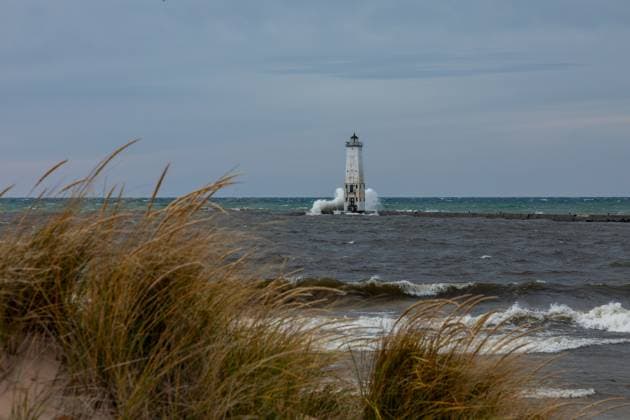 Looking through the beach grasses at the lighthouse Frankfort, Michigan, United States R_ORFW240521B1-1442306-01