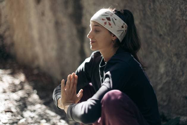 Woman meditating in a serene climbing area near Lake Garda, Italy Arco, Trentino-South Tyrol, Italy CR_MGTP240519-1377154-01 ,model released, Symbolfoto