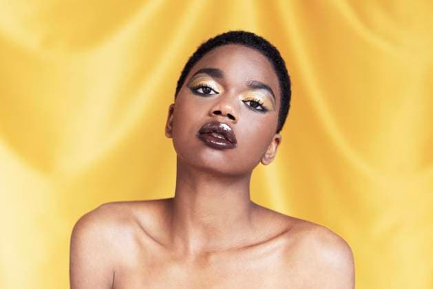 Creative Highlights Symbolbilder Beautiful woman with make-up against yellow background model released, Symbolfoto, LMCF01199