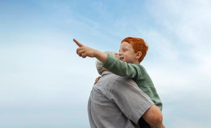 Creative Highlights Symbolbilder Grandfather holding redhead grandson in arms under sky model released, Symbolfoto, MBLF00388