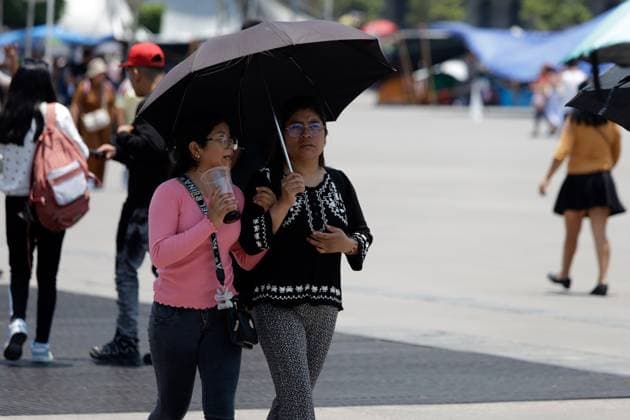 High Temperatures Hits Mexico City Two women drink refreshing drinks to hydrate themselves due the high temperatures hits the country, while walk, covering themselves from the sun with an umbrella in the Mexico City main square. on May 26, 2024 in Mexico City, Mexico. Mexico City CDMX Mexico Copyright: xLuisxBarronxxxEyepixxGroupx