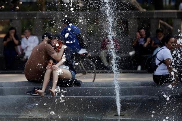 A couple cools off in the fountain at the historic center of Mexico due high temperatures that hits Mexico. Mexico City Mexico - ZUMAe321 20240528_zia_e321_001 Copyright: xLuisxBarronx