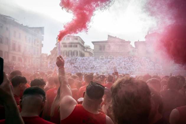 Reds supporters celebrate the victory at the end of the semifinal between Whites (Santo Spirito) and Reds (Santa Maria Novella) teams of Calcio Storico Fiorentino in Firenze (Italy), Santa Croce square, June 1st, 2024. The Calcio Storico Fiorentino (Florence Historical Football), also known as Calcio in Costume (costume football), is a team game with a ball that has remote origins and today is one of the oldest Florentine traditions. The game is a challenge between the four quarters of the city. Matches are played in 16th century costumes and every year a tournament is organised involving the city s four historic neighbourhoods: the Whites of Santo Spirito, the Blues of Santa Croce, the Reds of Santa Maria Novella and the Greens of IgnacioxCalcagno