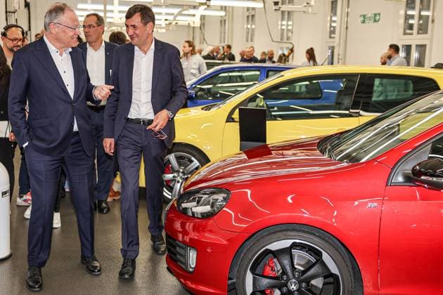 Celebration of 50 years of Golf production at Volkswagen in Wolfsburg Celebration of 50 years of Golf production, event room with various VW Golf cars, from left Nds Minister President Stephan Weil SPD , Gunnar Kilian, Member of the Board of Management of Volkswagen AG for Human Resources and Trucks Wolfsburg VW plant Wolfsburg Lower Saxony Germany