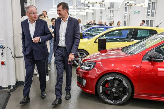 Celebration of 50 years of Golf production at Volkswagen in Wolfsburg Celebration of 50 years of Golf production, event room with various VW Golf cars, from left Nds Minister President Stephan Weil SPD , Gunnar Kilian, Member of the Board of Management of Volkswagen AG for Human Resources and Trucks Wolfsburg VW plant Wolfsburg Lower Saxony Germany