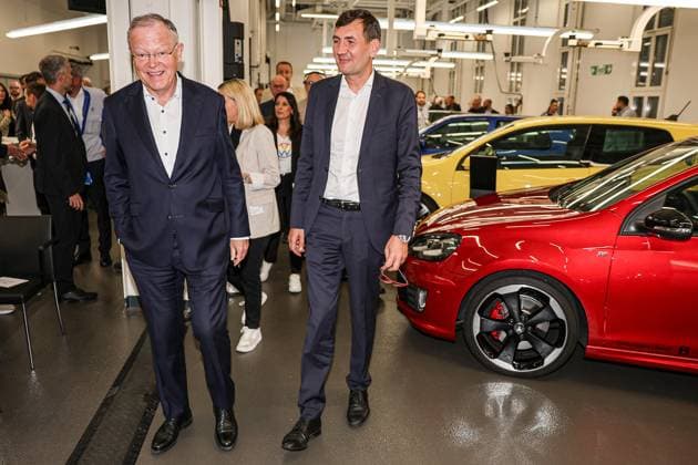 Celebration of 50 years of Golf production at Volkswagen in Wolfsburg Celebration of 50 years of Golf production, event room with various VW Golf cars, from left Nds Minister President Stephan Weil SPD , Gunnar Kilian, Member of the Board of Management of Volkswagen AG for Human Resources and Trucks Wolfsburg VW plant Wolfsburg Lower Saxony Germany