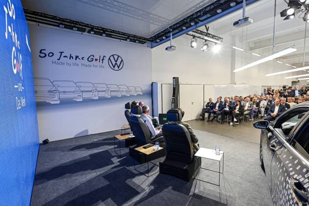 Ceremony 50 years of Golf production at Volkswagen in Wolfsburg Ceremony 50 years of Golf production, stage, right VW Golf VIII, panel discussion and guests in the event room Wolfsburg VW plant Wolfsburg Lower Saxony Germany