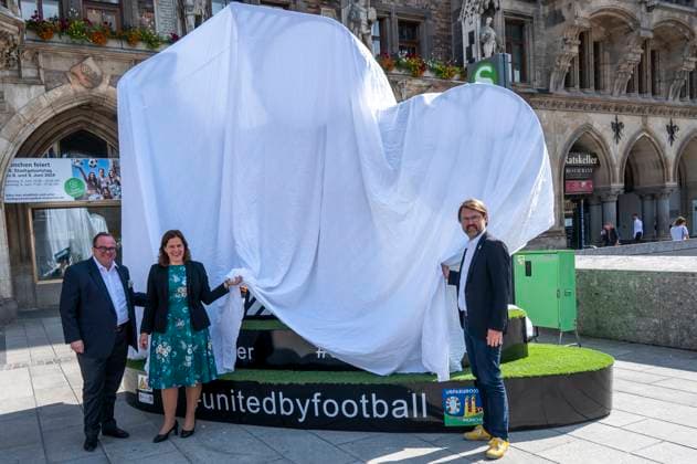 Mayor Verena Dietl, sports officer Florian Kraus and business officer Clemens Baumgäaertner unveil the Munich Kindl on Marienplatz, which will be part of the UEFA EURO 2024 Spectacular in Munich The larger-than-life figure is intended to invite all fans and visitors to linger and come together