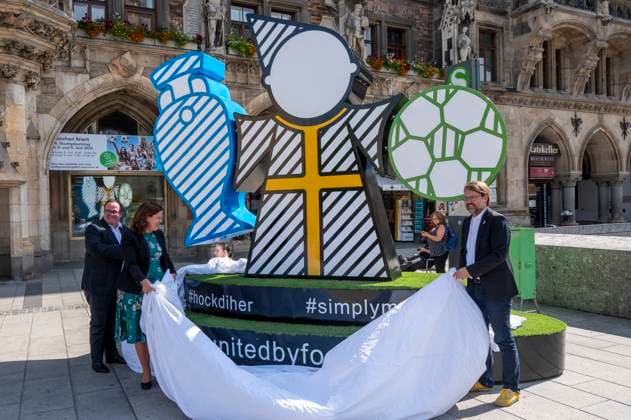 Mayor Verena Dietl, sports officer Florian Kraus and business officer Clemens Baumgäaertner unveil the Munich Kindl on Marienplatz, which will be part of the UEFA EURO 2024 Spectacular in Munich The larger-than-life figure is intended to invite all fans and visitors to linger and come together