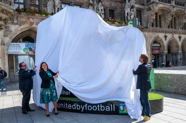 Mayor Verena Dietl, sports officer Florian Kraus and business officer Clemens Baumgäaertner unveil the Munich Kindl on Marienplatz, which will be part of the UEFA EURO 2024 Spectacular in Munich The larger-than-life figure is intended to invite all fans and visitors to linger and come together