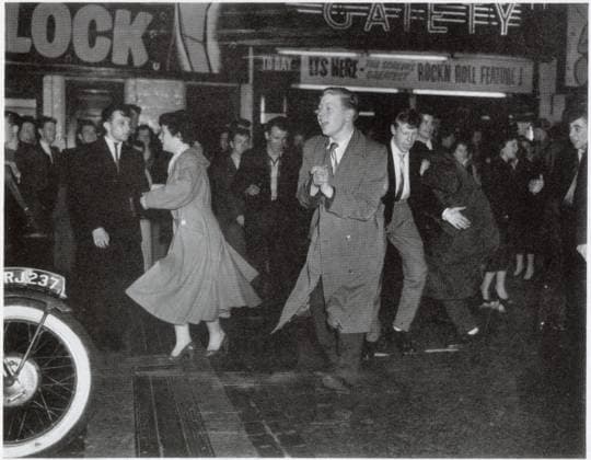 RECORD DATE NOT STATED Rock n roll riots in Manchester Teenagers dancing in the street and milling around outside the Gaiety Cinema in Manchester following a screening of Rock Around the Clock starring Bill Haley and the Comets. The film prompted a number teenage hoodlums to cause a disturbance and rip out some of the cinema s fittings. Police eventually had to be called to disperse the crowd. Date: 1956  Copyright: Copyrightx(c)Geminix2023.xCredit:xGemini 14062842