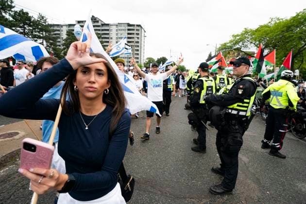 June 9, 2024, Toronto, On, Canada: A woman marches in the United Jewish AppealöÄÃ s annual Walk With Israel event as Pro-Palestinian protesters gather along the route in Toronto, on Sunday, June 9, 2024. Toronto Canada  - ZUMAc35_ 20240609_zaf_c35_014 Copyright: xArlynxMcadoreyx