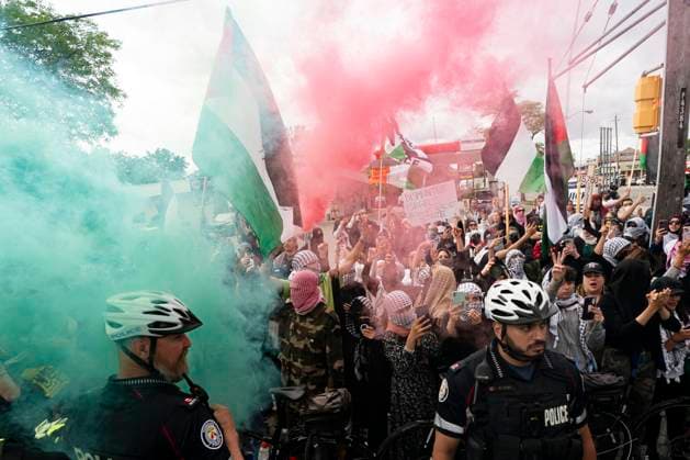 June 9, 2024, Toronto, On, Canada: Pro-Palestinian protesters release coloured smoke as they gather along the route of the United Jewish AppealöÄÃ s annual Walk With Israel march in Toronto, on Sunday, June 9, 2024. Toronto Canada  - ZUMAc35_ 20240609_zaf_c35_051 Copyright: xArlynxMcadoreyx