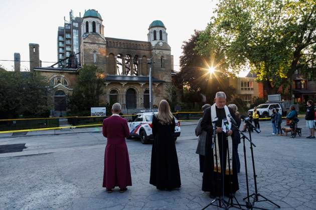 June 11, 2024, Toronto, On, CANADA: Rev. Don Beyers leads a group in a moment of silence alongside a group of parishioners and community members out front of the burnt out St. Anne s Anglican Church, during an evening vigil to mourn the loss of the church following a Sunday morning fire, Tuesday, June 11, 2024. Toronto CANADA  - ZUMAc35_ 20240611_zaf_c35_097 Copyright: xColexBurstonx