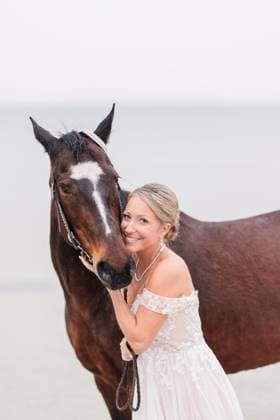 Creative Highlights Symbolbilder Smiling bride in lace wedding dress hugging a horse by the water Falmouth, Massachusetts, United States R_XRKW240611-1454491-01 ,model released, Symbolfoto