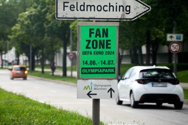 Munich, Bavaria, Germany - 14 June 2024: Poster for the European Football Championship for public viewing in a fan zone, zone for fans in the Olympic Park with a signpost on a street