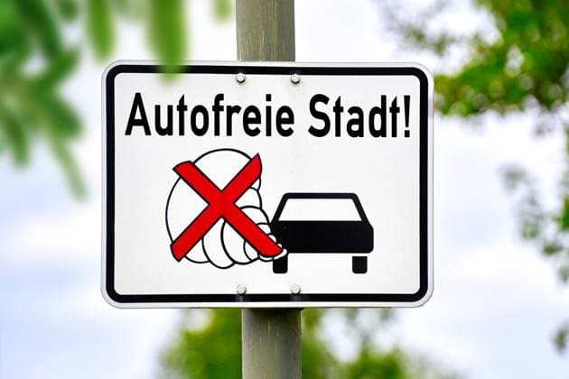 Germany - June 18, 2024: Traffic sign: Car-free city, with car ban symbol. Symbolic image of sustainability and better air quality in cities. PHOTOMONTAGE *** Verkehrsschild: Autofreie Stadt, mit Auto Verbotssymbol. Symbolbild Nachhaltigkeit und bessere Luftqualität in Städten. FOTOMONTAGE
