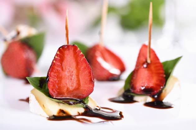 Brie snacks with strawberries and basil Strawberries, cheese, fresh basil and balsamic come together for a bite-sized appetizer Copyright: xZoonar.com VORONOVA_MARYNAx 21751228