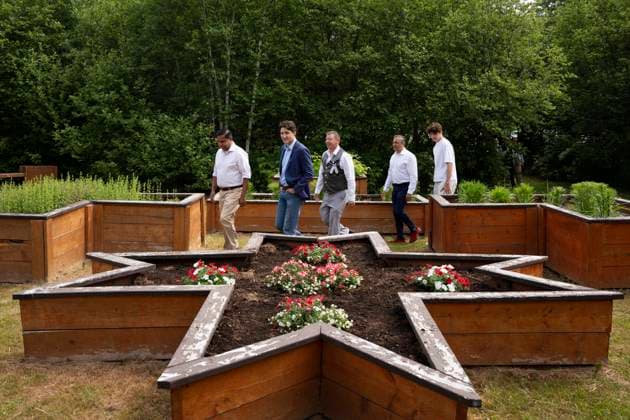 June 21, 2024, WeöÄà KoqmaöÄà Q First Nat, Ns, Canada: Prime Minister Justin Trudeau, second from left, with his son Xavier, right, walks past a garden shaped in the Mi kmaq Star with, from left to right, CrownöÄìIndigenous Relations Minister Gary Anandasangaree, Liberal MP for Sydney-Victoria Jaime Battiste, and Liberal MP for Cape BretonöÄiCanso Mike Kelloway during an event for National Indigenous Peoples Day in We koqma q First Nation, N.S. on Friday, June 21, 2024. WeöÄà KoqmaöÄà Q First Nat Canada - ZUMAc35_ 20240621_zaf_c35_021 Copyright: xDarrenxCalabresex