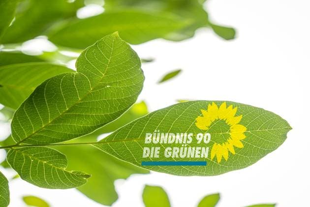 Germany - June 22, 2024: The logo of the party Bündnis 90, die Grünen with yellow sunflower and the lettering of the governing party. Symbolizes a strong connection to nature and emphasizes the environmentally friendly and sustainable values and environmental policy of the Green Party. PHOTOMONTAGE *** Das Logo der Partei Bündnis 90, die Grünen mit gelber Sonnenblume und dem Schriftzug der Regierungspartei. Symbolisiert, starke Verbindung zur Natur und betont die umweltfreundlichen und nachhaltigen Werte, sowie Umweltpolitik der grünen Partei. FOTOMONTAGE
