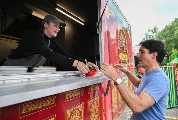 June 23, 2024, Chateauguay, Pq, Canada: Prime Minister Justin Trudeau receives a poutine from Mathilde Mevel as he visits a poutine festival in Chateauguay, Que., Sunday, June 23, 2024. Chateauguay Canada  - ZUMAc35_ 20240623_zaf_c35_002 Copyright: xGrahamxHughesx
