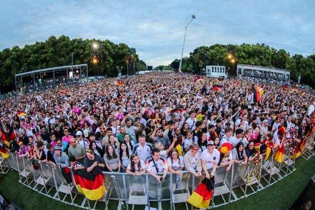 Euro 2024 public viewing in Berlin Germany vs. Austria, fan zone in front of the Brandenburg Gate The fans cheer on the team and hold up a trophy Berlin Berlin Germany