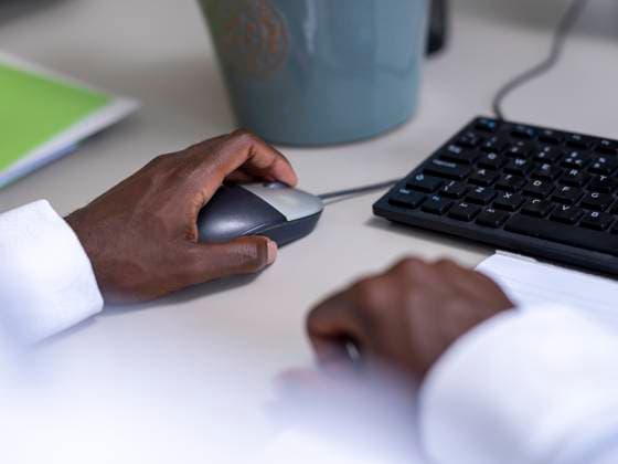 Close-up of hands using computer at desk model released Copyright: xCulturaxCreativex