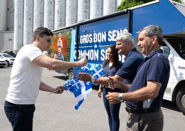 June 24, 2024, Quebec, Pq, Canada: Conservative Leader Pierre Poilievre, left, hands Quebec flags to MPs Gerard Deltell, centre and Pierre Paul-Hus, as wife Anaida looks on while touring the province for the Fete nationale, in Quebec City, Monday, June 24, 2024. Quebec Canada  - ZUMAc35_ 20240624_zaf_c35_037 Copyright: xJacquesxBoissinotx