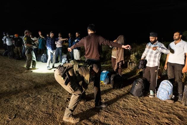 JACUMBA HOT SPRINGS, CA - JUNE 24: Migrants queue up to be processed by U.S. Border Patrol agents after crossing into U.S. from Mexico through an abandoned railroad on June 24, 2024 in Jacumba Hot Springs, San Diego, California.  Copyright: xVCGx 111503898898