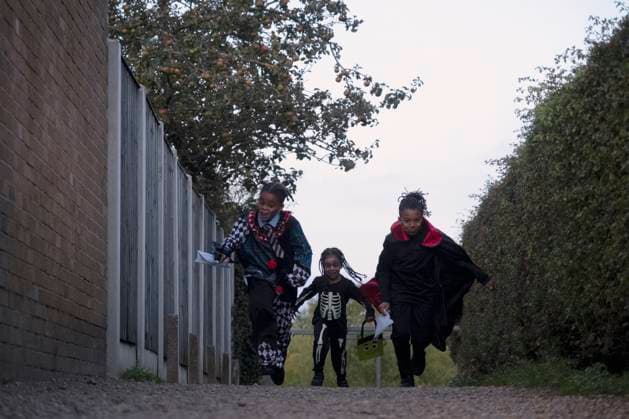 Children in Halloween costumes running on footpath model released Copyright: xCCOx