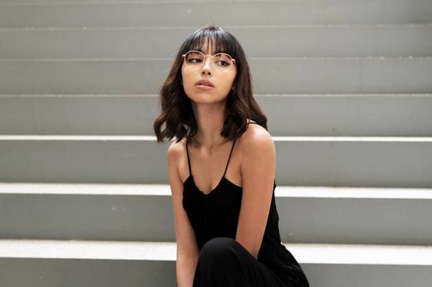 Creative Highlights Symbolbilder Young woman with bangs positing sitting on steps model released, Symbolfoto property released, LMCF01221