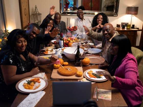Family having video call during Thanksgiving dinner model released Copyright: xCCOx