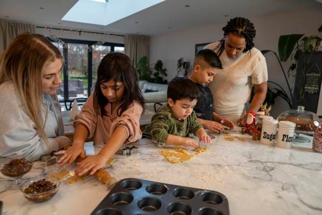 Moms with kids preparing Christmas cookies in kitchen model released Copyright: xCCOx