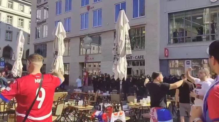 VIDEO: Serbian footy thugs lob beer bottles at German cops in ugly Euro 2024 scenes Story from Jam Press (Serbian Fans Throw Bottles) Pictured: A video grab of Serbian football thugs lobbing beer bottles at German riot cops. VIDEO: Serbian footy thugs lob beer bottles at German cops in ugly Euro 2024 scenes Serbian football thugs lobbed beer bottles at German riot cops in ugly scenes at Euro 2024. A mob of supporters targeted the police officers in the main square in Munich. It was ahead of their match last (25 Jun) night with Denmark that ended 0-0. Serbia, in Group C along with England, were knocked out after finishing bottom. Some of their fans were topless, while others were clad in their football shirts and draped in their nati  Copyright: xJamxPressxVid @footbalIfights