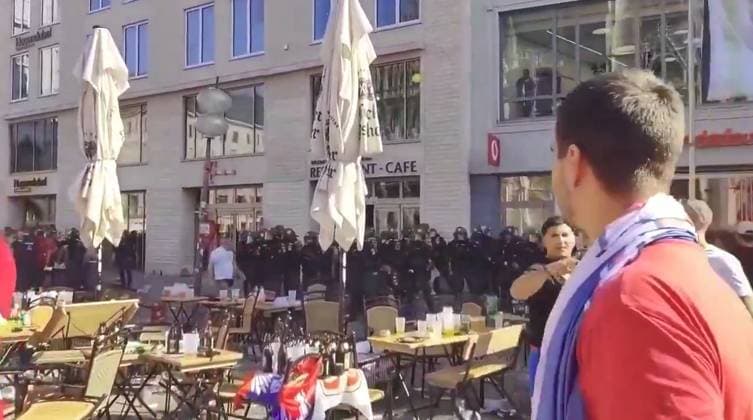 VIDEO: Serbian footy thugs lob beer bottles at German cops in ugly Euro 2024 scenes Story from Jam Press (Serbian Fans Throw Bottles) Pictured: A video grab of Serbian football thugs lobbing beer bottles at German riot cops. VIDEO: Serbian footy thugs lob beer bottles at German cops in ugly Euro 2024 scenes Serbian football thugs lobbed beer bottles at German riot cops in ugly scenes at Euro 2024. A mob of supporters targeted the police officers in the main square in Munich. It was ahead of their match last (25 Jun) night with Denmark that ended 0-0. Serbia, in Group C along with England, were knocked out after finishing bottom. Some of their fans were topless, while others were clad in their football shirts and draped in their nati  Copyright: xJamxPressxVid @footbalIfights