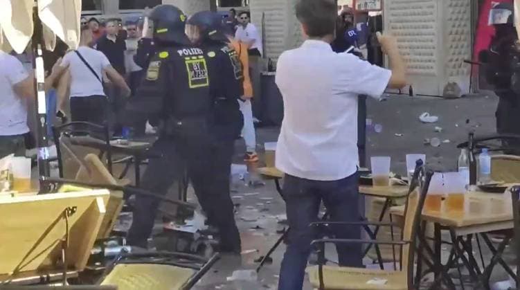 VIDEO: Serbian footy thugs lob beer bottles at German cops in ugly Euro 2024 scenes Story from Jam Press (Serbian Fans Throw Bottles) Pictured: A video grab of Serbian football thugs lobbing beer bottles at German riot cops. VIDEO: Serbian footy thugs lob beer bottles at German cops in ugly Euro 2024 scenes Serbian football thugs lobbed beer bottles at German riot cops in ugly scenes at Euro 2024. A mob of supporters targeted the police officers in the main square in Munich. It was ahead of their match last (25 Jun) night with Denmark that ended 0-0. Serbia, in Group C along with England, were knocked out after finishing bottom. Some of their fans were topless, while others were clad in their football shirts and draped in their nati  Copyright: xJamxPressxVid @footbalIfights