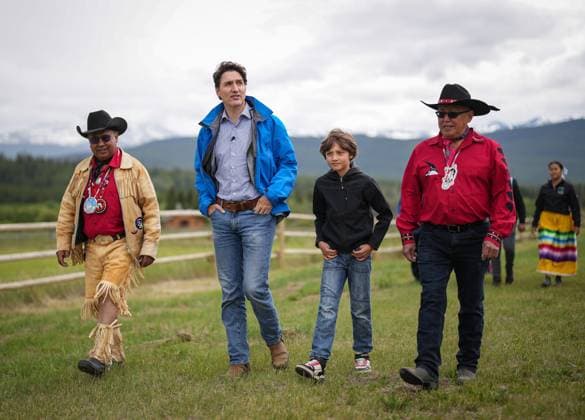 June 26, 2024, Nemaiah Valley, Bc, CANADA: Prime Minister Justin Trudeau, second left, and his son Hadrien, 10, walk with Chief Roger William, left, and Chief Otis Guichon as they arrive for community celebrations to mark the 10th anniversary of the Tsilhqot in decision, in Nemaiah Valley, B.C., on Wednesday, June 26, 2024. In 2014, the Supreme Court of Canada granted Tsilhqot in aboriginal title to more than 1,750 square kilometres of land in the Nemiah Valley. Nemaiah Valley CANADA - ZUMAc35_ 20240626_zaf_c35_076 Copyright: xDarrylxDyckx
