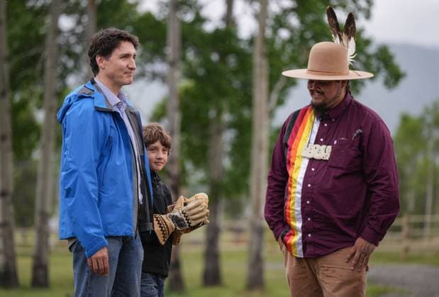 June 26, 2024, Nemaiah Valley, Bc, CANADA: Prime Minister Justin Trudeau stands with his son Hadrien, 10, after he received a pair of gloves from Peyal Lacesse, right, that were made by his mother, while attending community celebrations to mark the 10th anniversary of the Tsilhqot in decision, in Nemaiah Valley, B.C., on Wednesday, June 26, 2024. In 2014, the Supreme Court of Canada granted Tsilhqot in aboriginal title to more than 1,750 square kilometres of land in the Nemaiah Valley. Nemaiah Valley CANADA - ZUMAc35_ 20240626_zaf_c35_141 Copyright: xDarrylxDyckx