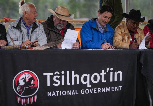 June 26, 2024, Nemaiah Valley, Bc, CANADA: Prime Minister Justin Trudeau, third left, sits between Chief Joe Alphonse, second left, and Chief Roger William, right, as they and B.C. Minister of Indigenous Relations and Reconciliation Murray Rankin, left, sign an extension of a tripartite agreement for another five years, during community celebrations to mark the 10th anniversary of the Tsilhqot in decision, in Nemaiah Valley, B.C., on Wednesday, June 26, 2024. In 2014, the Supreme Court of Canada granted Tsilhqot in aboriginal title to more than 1,750 square kilometres of land in the Nemaiah Valley. Nemaiah Valley CANADA - ZUMAc35_ 20240626_zaf_c35_151 Copyright: xDarrylxDyckx