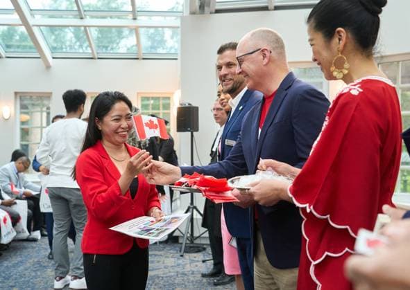July 1, 2024, Winnipeg, Mb, Canada: New Canadian citizen Marilou Martin, originally from the Philippines, is handed a Canadian flag by Winnipeg MayorScott Gillingham during a Canada Day citizenship ceremony at the Assiniboine Park Pavilion in Winnipeg, Man., Monday July 1, 2024. Winnipeg Canada  - ZUMAc35_ 20240701_zaf_c35_050 Copyright: xDavidxLipnowskix