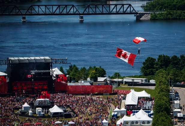 July 1, 2024, Ottawa, On, CAN: A member of the Skyhawks Parachute Team passes over people attending the Canada Day noon hour show at LeBreton Flats, during a flypast celebrating the RCAF centennial, in Ottawa, on Monday, July 1, 2024. Ottawa CAN  - ZUMAc35_ 20240701_zaf_c35_098 Copyright: xJustinxTangx